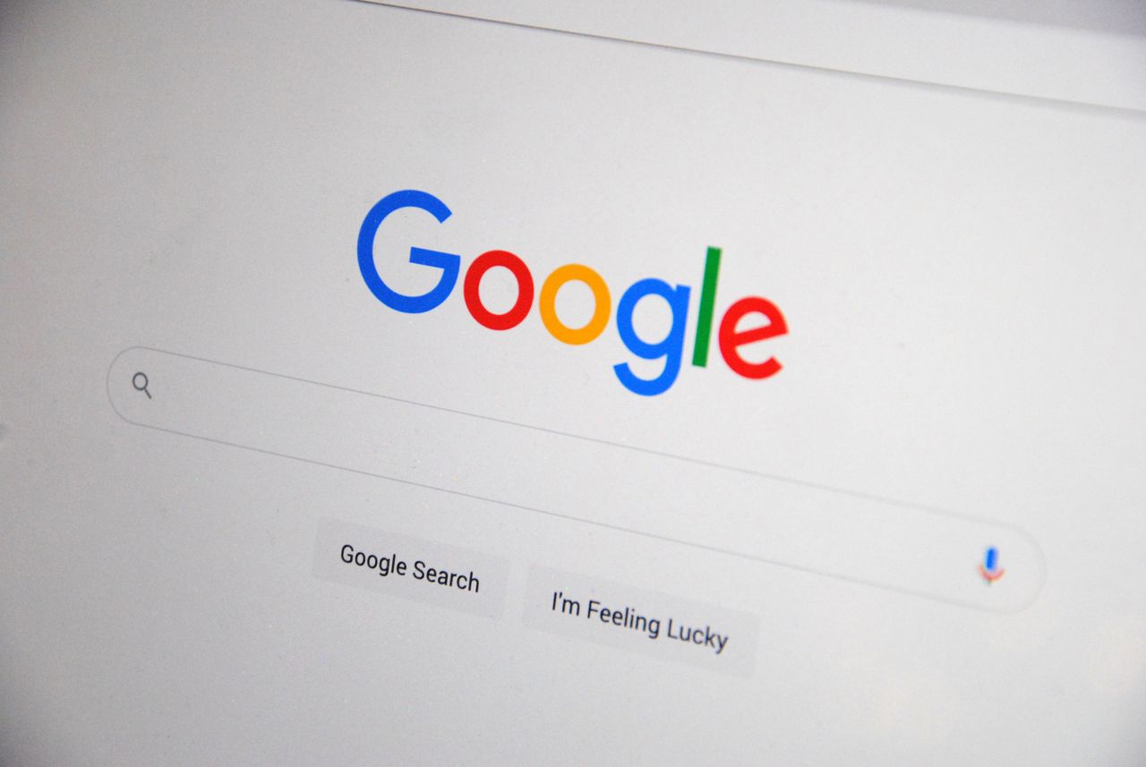 about-me-01 Close-up of the Google homepage on a screen showing search options.