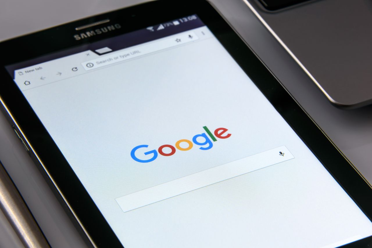 our-journey-03 Close-up of a tablet displaying Google's search screen, emphasizing technology and internet browsing.